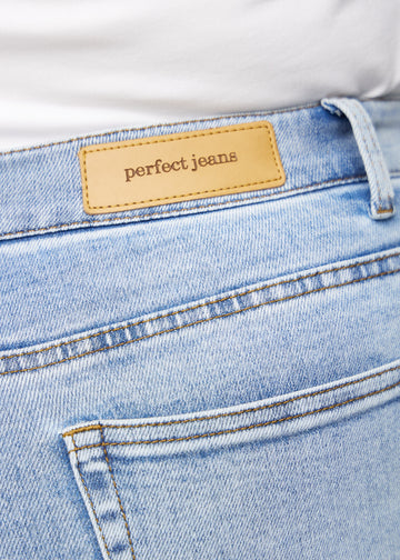 Närbild av ljusblå denim med Perfect Jeans läderpatch baktill i midjan, på en plus-size modell.