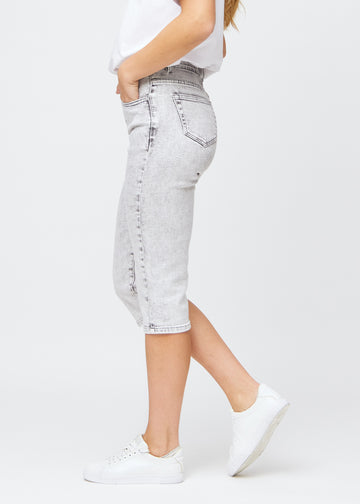 Kvinna iklädd ljusgrå regular denim capris