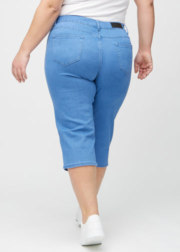 Blå regular capris sedda bakifrån på en plus-size-modell, så att man kan se hela produkten.