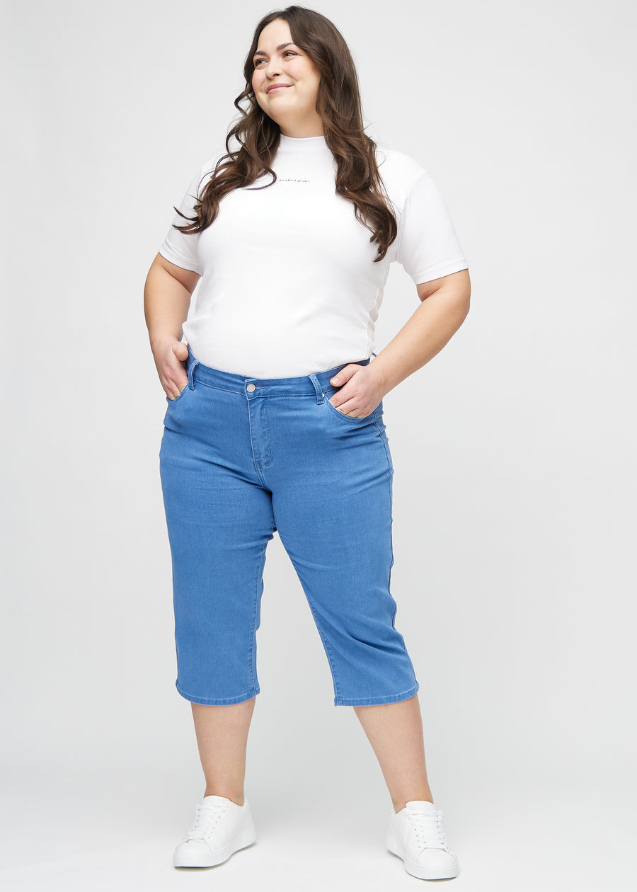 Helbild av en plus-size-modell i blå regular capris.