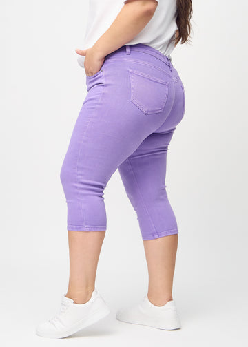 Skinnycapris för kvinnor i pastellila jeanstyg, färgen Lavenders. Från sidan på en plus size-modell, med åtsittande passform.