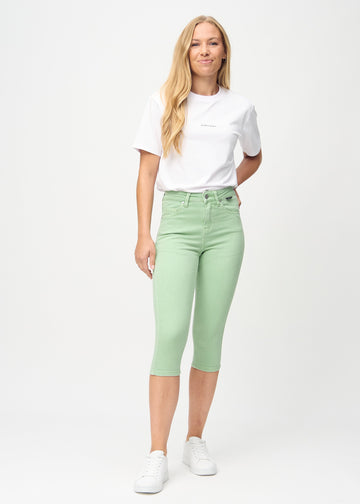 Skinnycapris för kvinnor i pastellgrönt jeanstyg, färgen Mints. Helbild av en modell som bär capris.