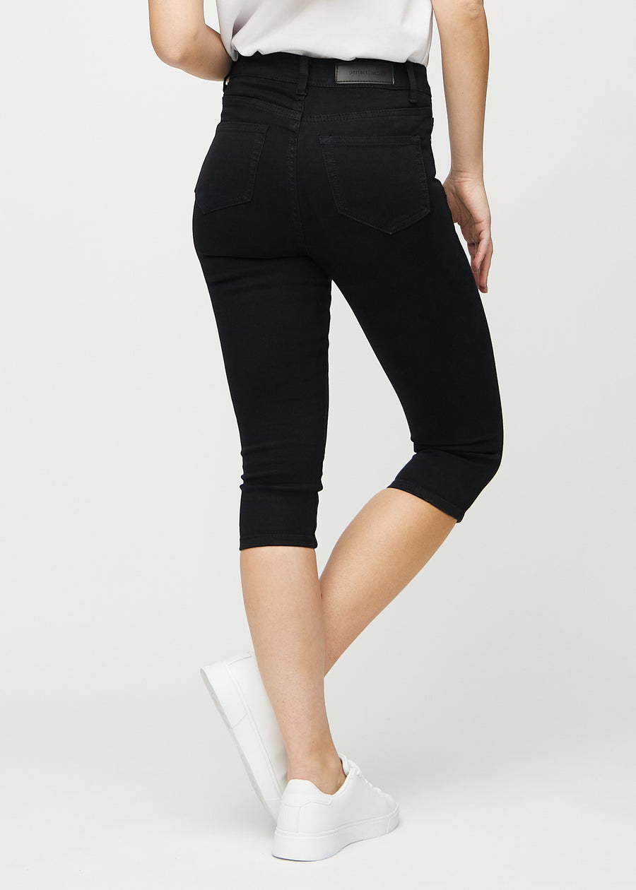Svarta skinny capris sedda bakifrån, så att hela produkten syns.