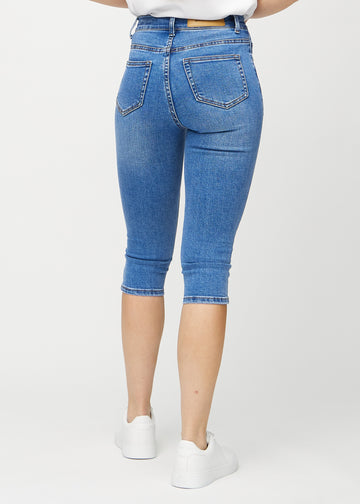 Denim skinny capris sedd bakifrån, så att man kan se hela produkten.