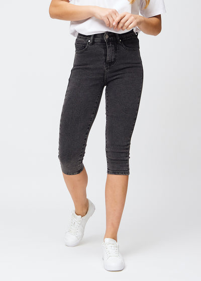 Skinnycapris för kvinnor i mörkgrå denim, färgen Shadows. Framifrån på en modell, med åtsittande ben till strax under knät.