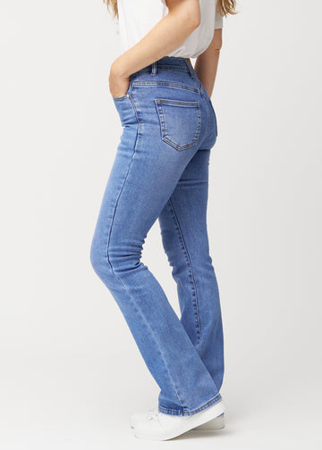 Blå mid-rise bootcutjeans i färgen Rivers. Från sidan på en modell.
