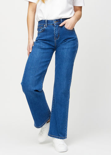 Loose jeans för kvinnor i mörkblå, färgen Oceans. Framifrån på en modell, med rymlig passform och vida ben.