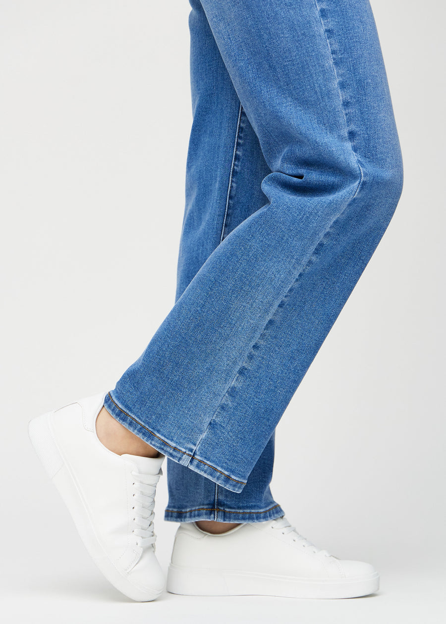 Loose jeans för kvinnor i blå, färgen Rivers. Närbild vid anklarna på en modell, som visar de vida bensluten.