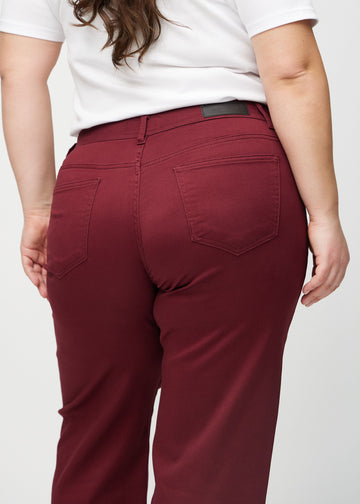 Loose jeans för kvinnor i mörkröd, färgen Santas. Närbild bakifrån på en plus size-modell, som visar passform och detaljer.
