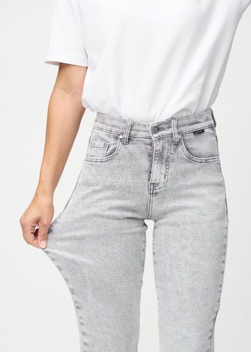 Regularjeans för kvinnor i ljusgrå, färgen Ashes. En modell drar i tyget vid låret för att visa stretchen.