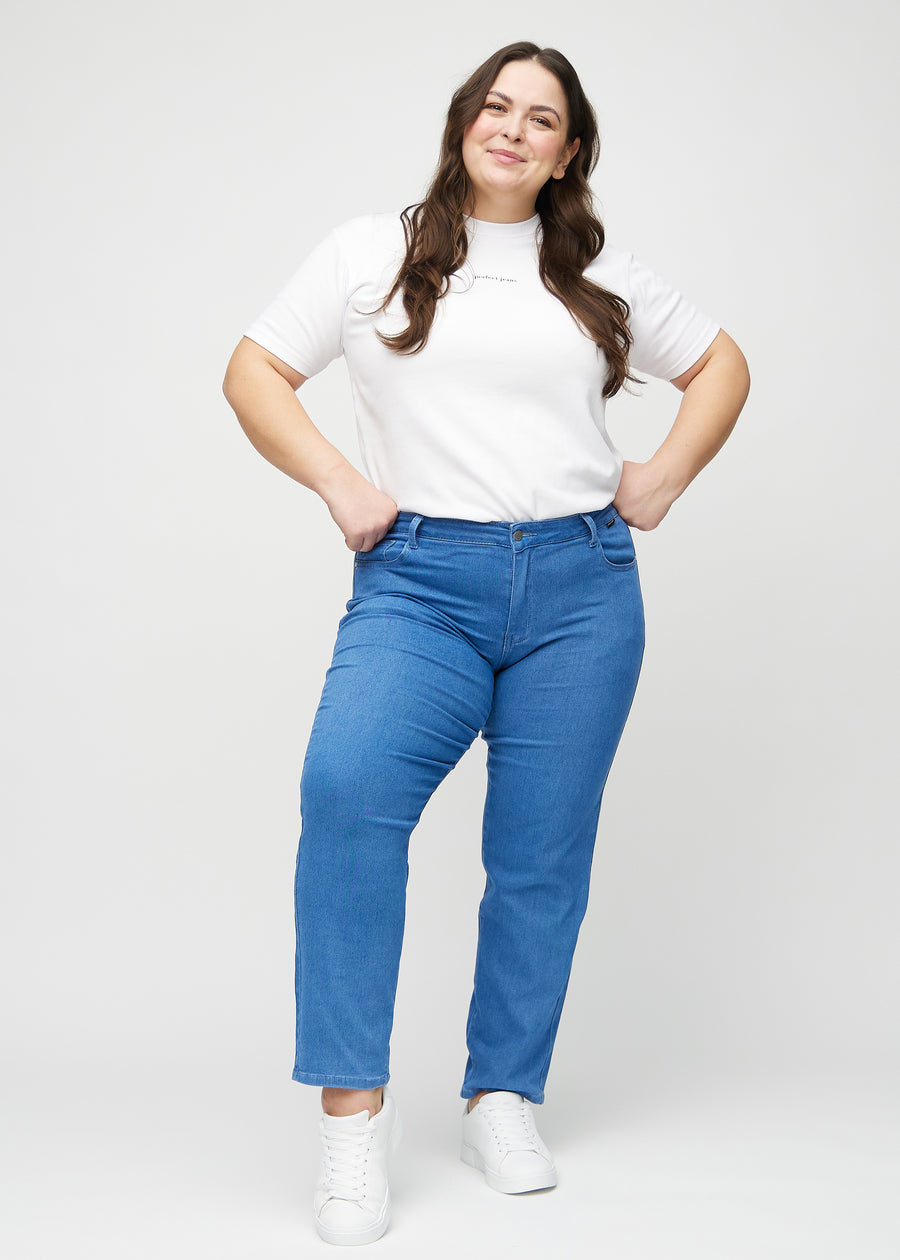 Regularjeans för kvinnor i blå, färgen Geraniums. Helbild av en plus size-modell som bär jeansen.