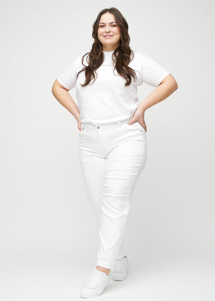 Regularjeans för kvinnor i vit, färgen Marguerites. Helbild av en plus size-modell som bär jeansen.