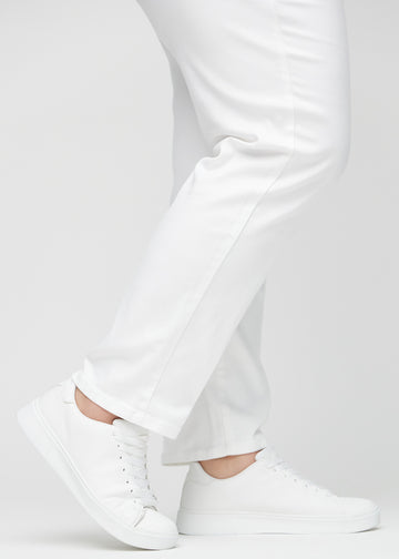 Regularjeans för kvinnor i vit, färgen Marguerites. Närbild vid anklarna på en plus size-modell, som visar de raka bensluten.