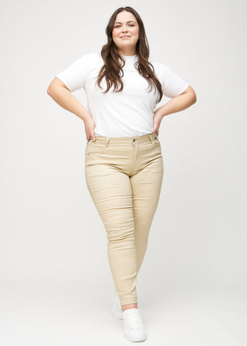 Skinnyjeans för kvinnor i beige, färgen Gazelles. Helbild av en plus size-modell som bär jeansen.