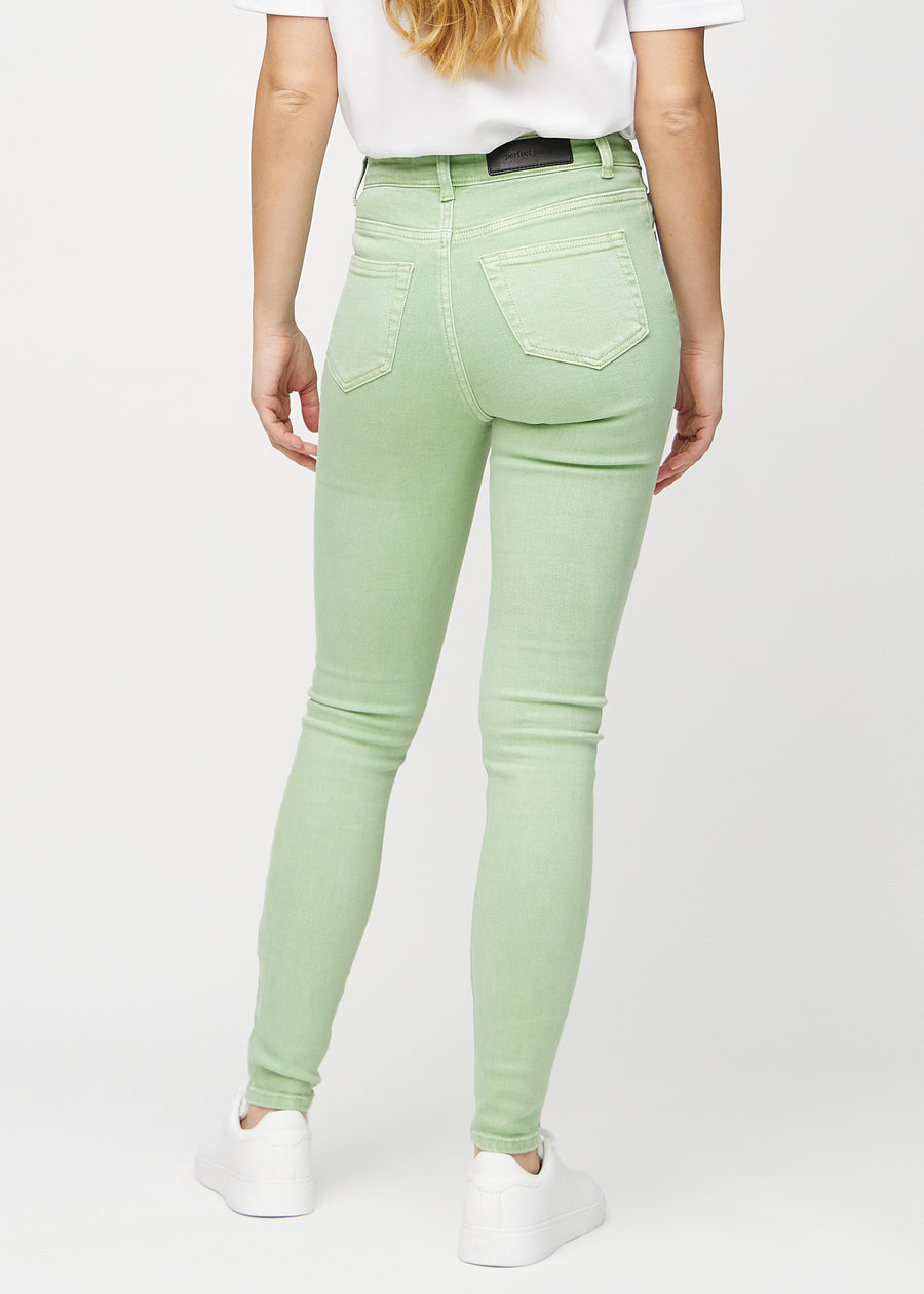 Ljusgröna skinny jeans sedda bakifrån, så att man kan se hela produkten.