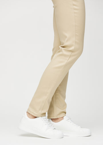 Slimjeans för kvinnor i beige, färgen Gazelles. Närbild vid anklarna på en modell som visar passformen vid bensluten.
