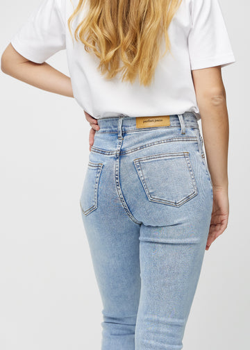 Slimjeans för kvinnor i ljusblå, färgen Waves. Närbild bakifrån på en modell som visar detaljerna.