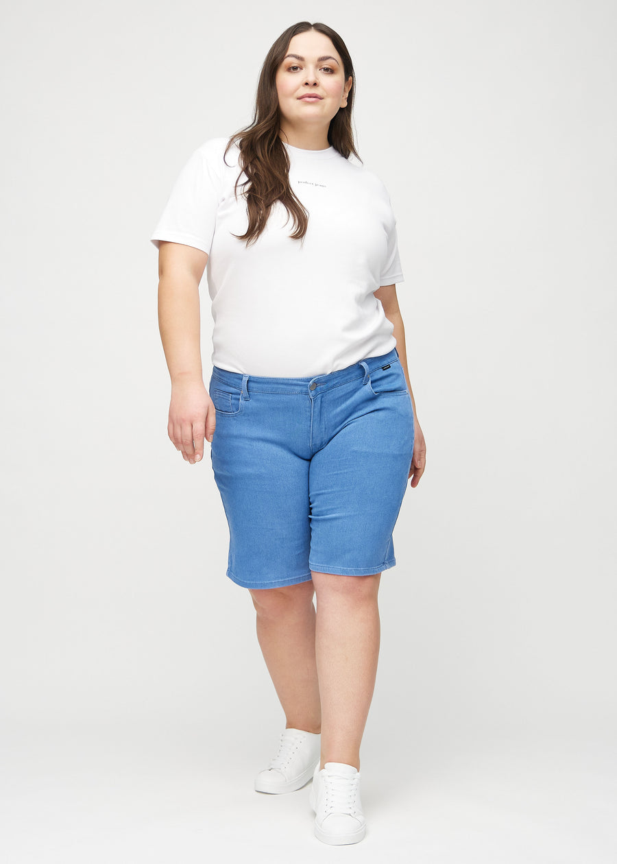Helbild av en plus-size-modell i blå regular middle shorts.