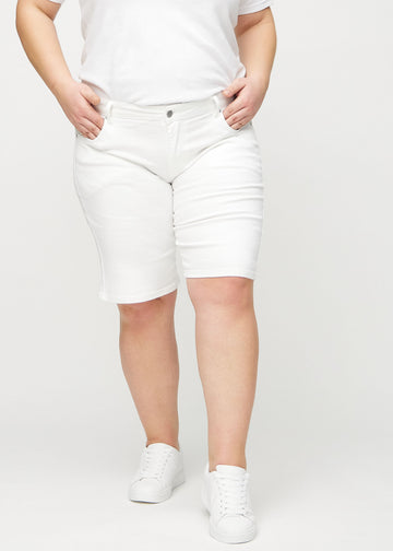 Vita regular middle shorts, modellnamn Marguerites, som går rakt ner längs benet och slutar precis ovanför knät på en plus size-modell, sedda framifrån.