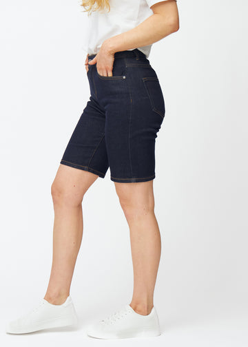 Mörkblå denimshorts för dam i färgen Midnights med regular passform sett från sidan på modell.