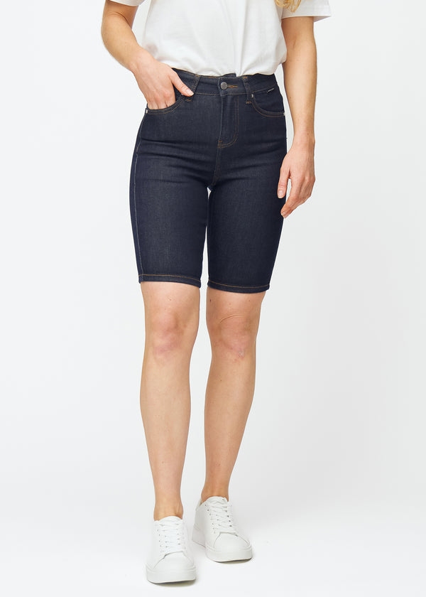 Mörkblå denimshorts för dam i färgen Midnights med skinny passform som sitter tätt vid höften och följer låren, sett framifrån.