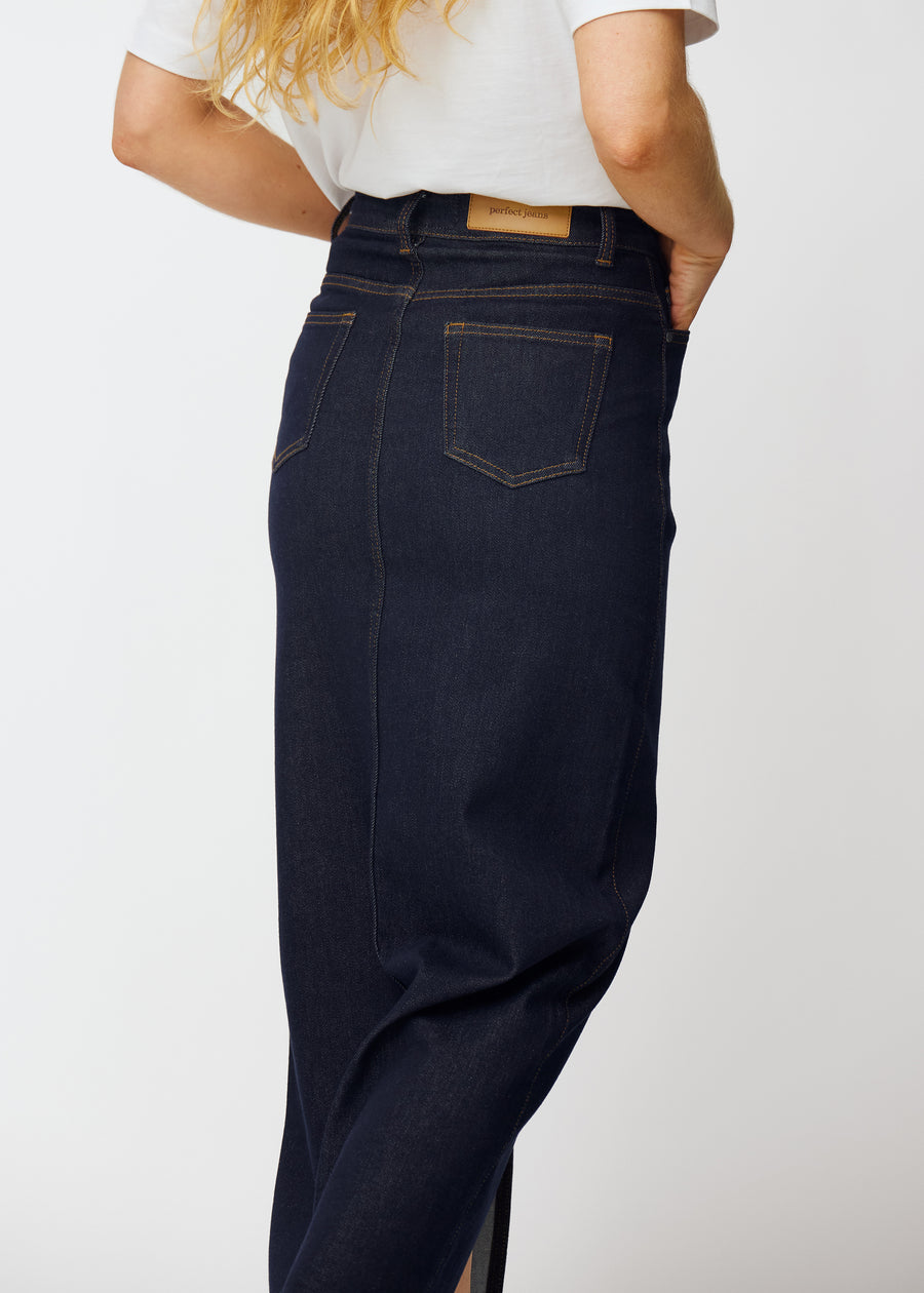 Lång mörkblå denimkjol för dam i färgen Midnights sett bakifrån i närbild för att visa passform och detaljer.
