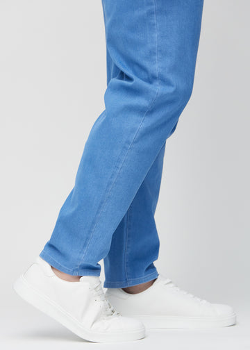 Anklarna på en plus-size-modell, så att man kan se hur löst jeansen sitter.