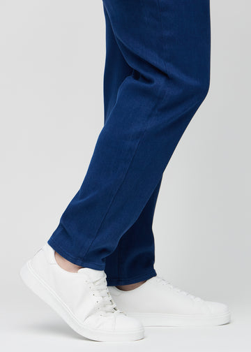 En plus-size-modells anklar, så att man kan se hur löst jeansen sitter.
