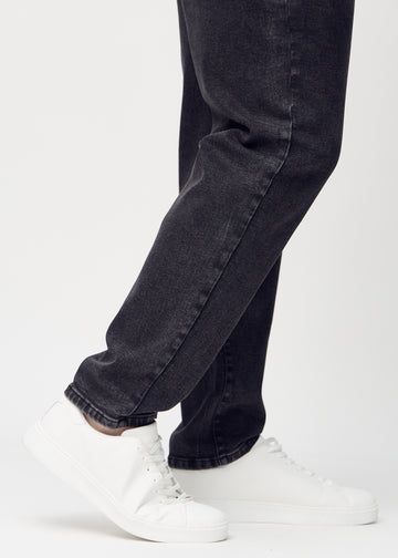 Anklarna på en plus-size-modell, så att man kan se hur löst jeansen sitter.