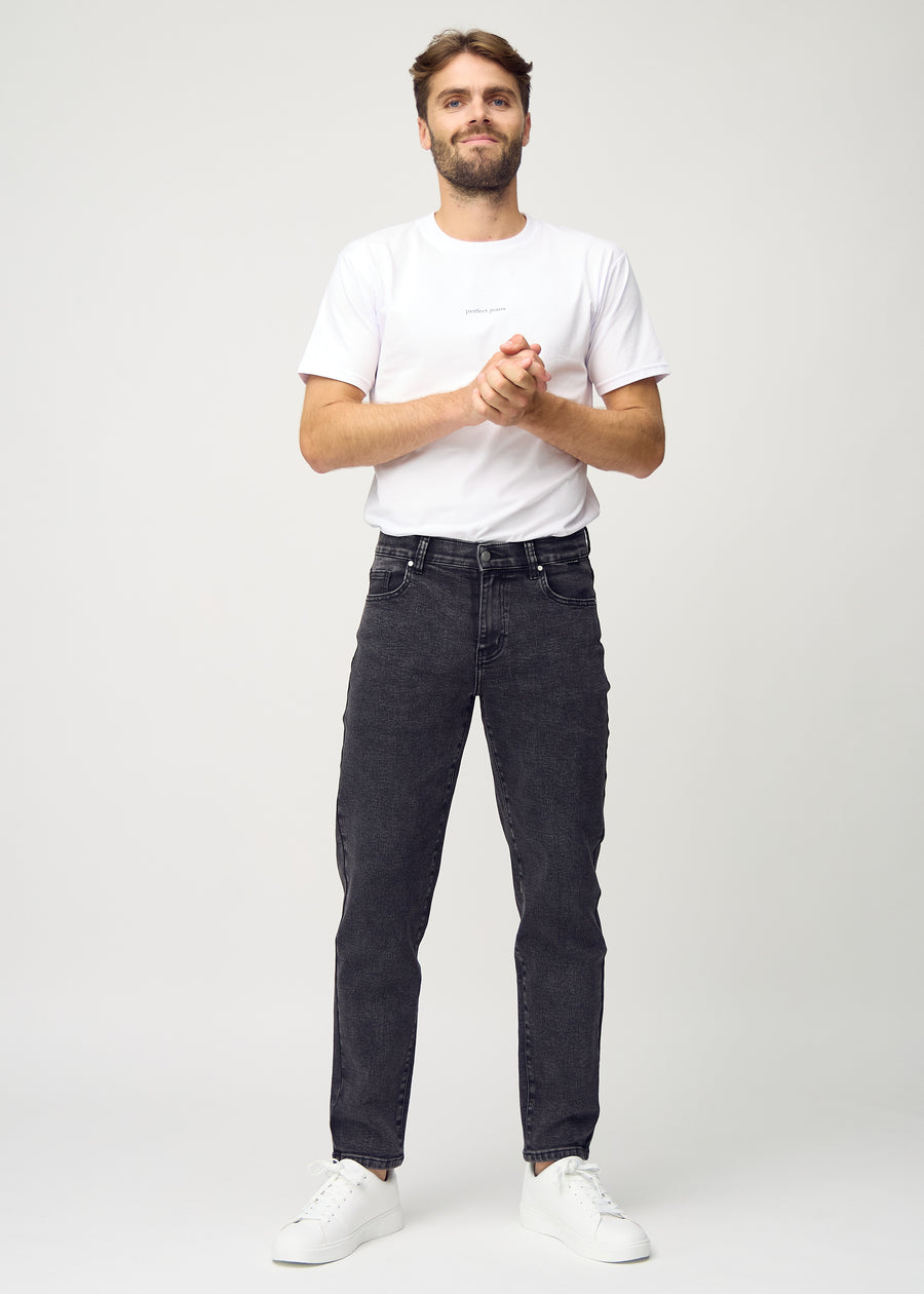 Helbild av modell i mörkgrå denim regular jeans.