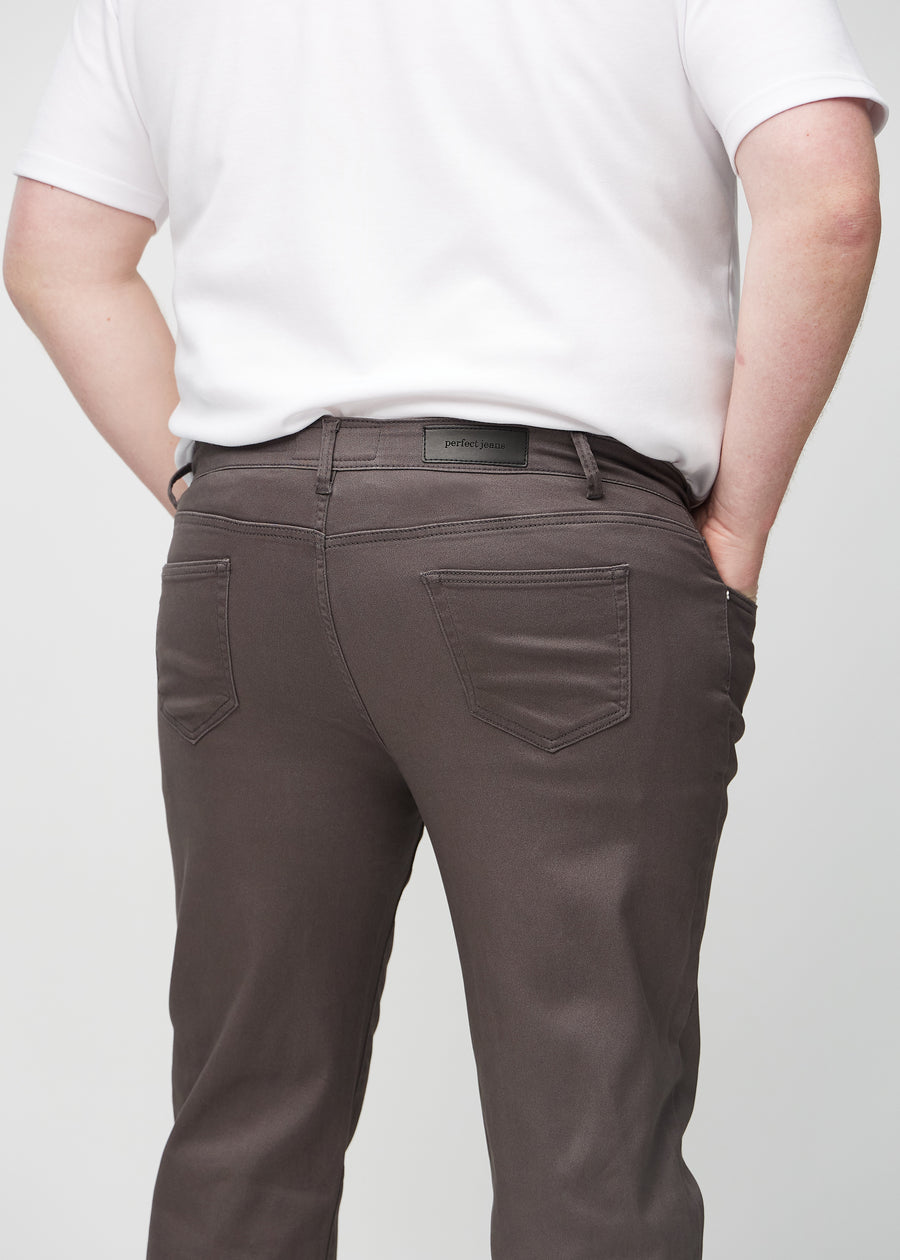 Gråbruna regular jeans sedda bakifrån i närbild på en plus size-modell för att visa detaljer.