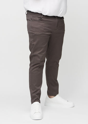 Gråbruna jeans i slim fit, modellnamn Thunders, som sitter tätt längs benen på en plus size-modell, sedda framifrån.