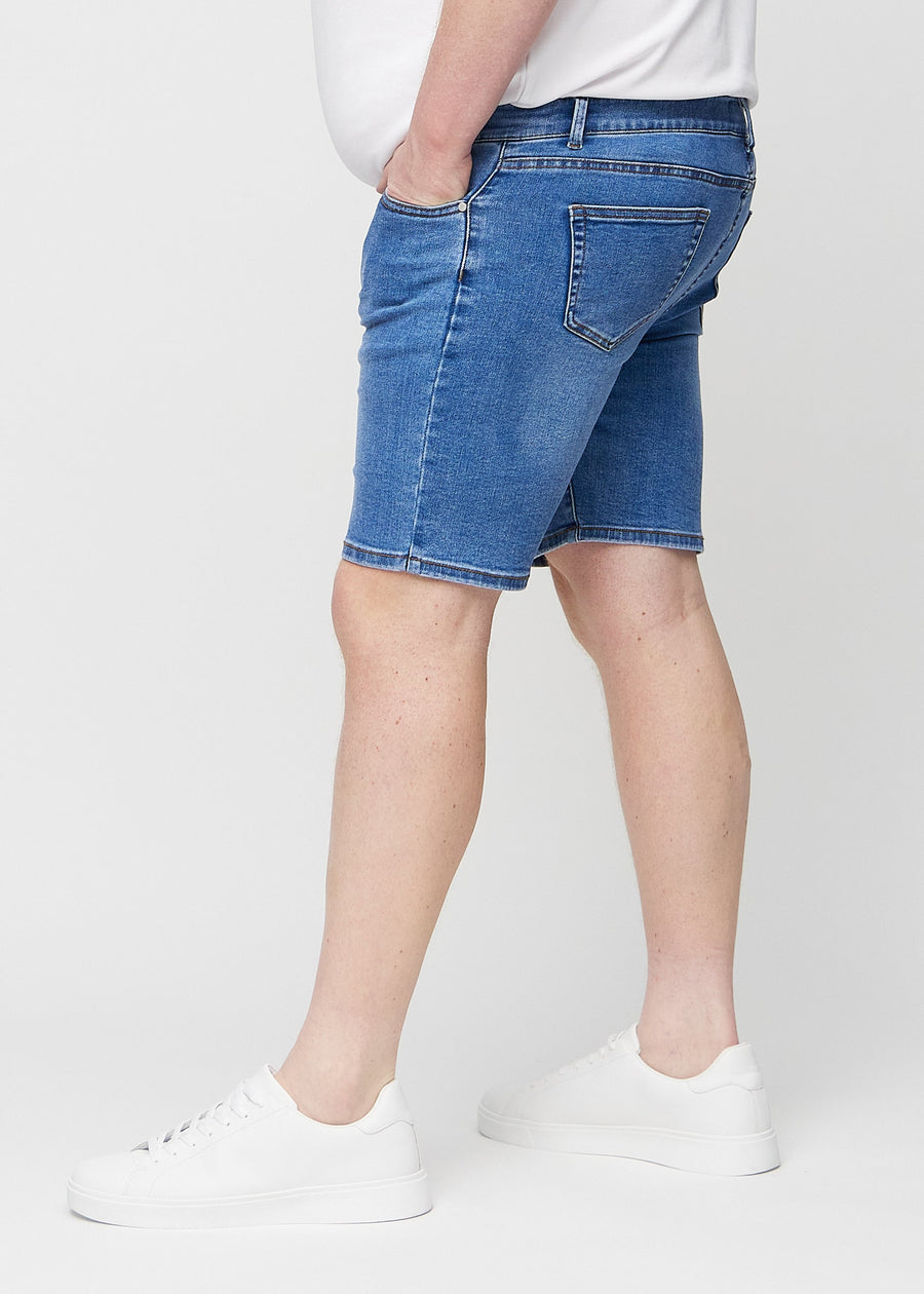Denim middle-slim shorts set fra siden på en plus-size model.