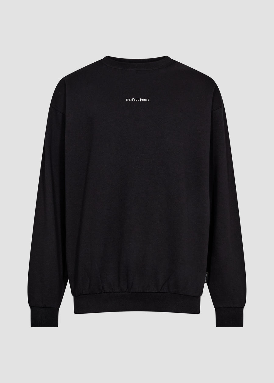 Svart unisex-sweatshirt från Perfect Jeans med vit logotyp mitt på bröstet, sedd framifrån.